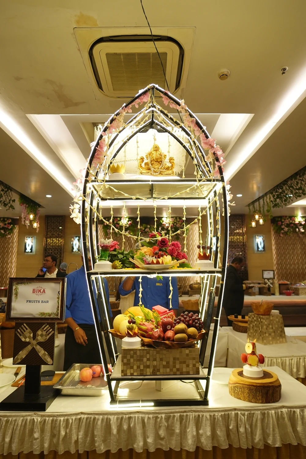 Illuminated boat fruit bar and Ganesha sculpture at Bika Rhythm, Baguiati